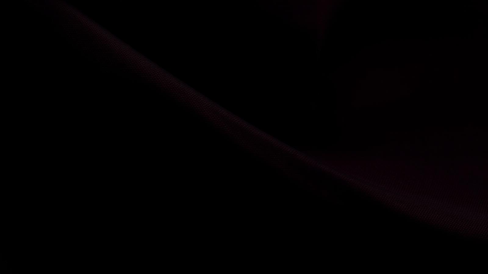 Dark silk fabric lit in deep crimson
